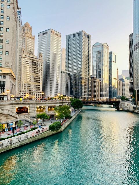 The Chicago Riverwalk curving along the river below downtown buildings